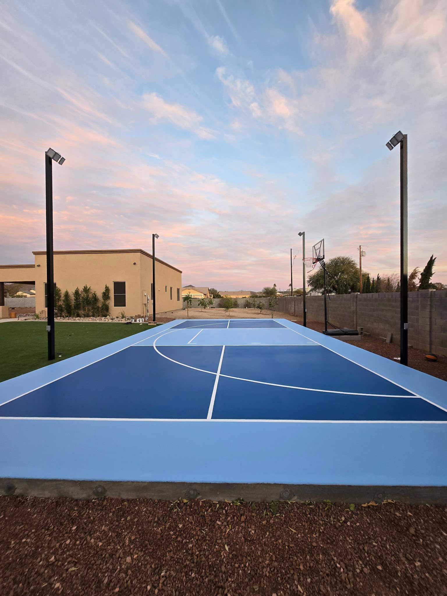 Blue pickleball and basketball court with court lighting